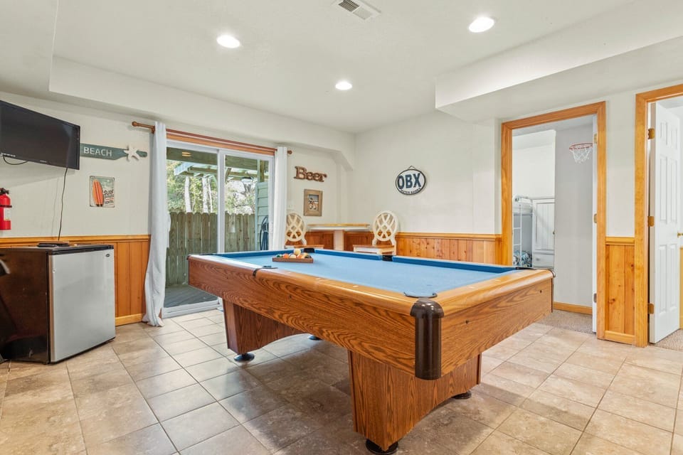 Enjoy friendly competition with a full-size pool table and entertainment area.