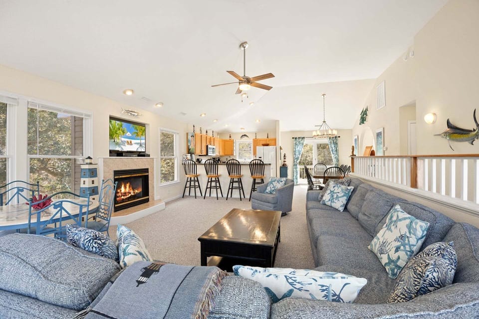 The open-concept living area features vaulted ceilings, abundant natural light, and comfortable seating for the whole family.