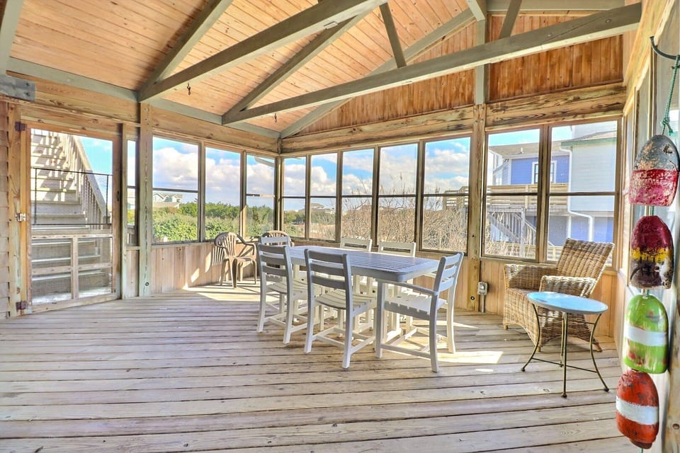 The screened porch provides a shaded, breezy spot to enjoy morning coffee or evening cocktails.