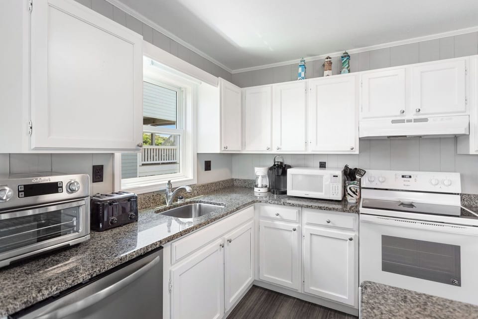 Whip up something delicious in the modern Kitchen with a flat-top stove and bar seating for 3!