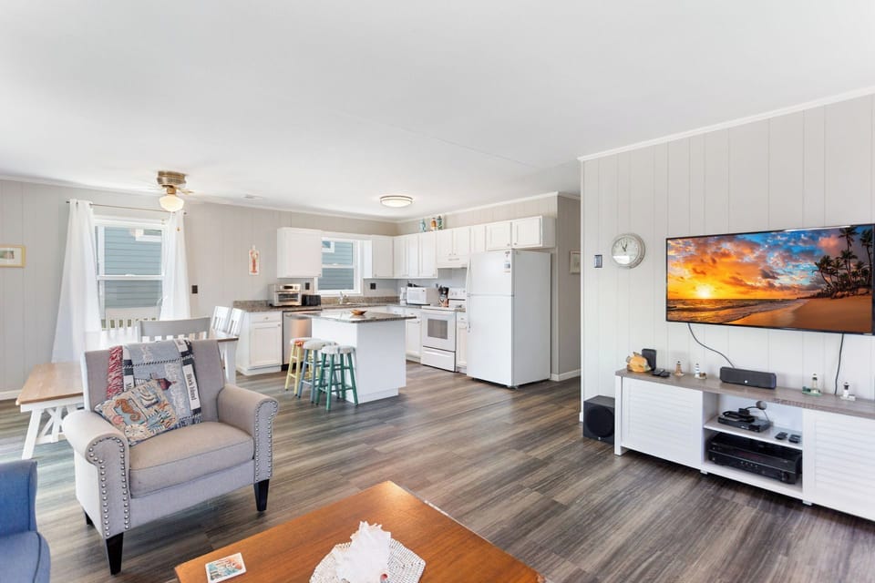 Relax in the bright, spacious Living Area with cozy furniture and a Flat Screen TV!