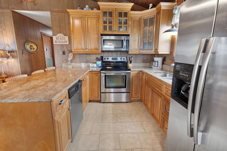 Whip up something delicious in the gorgeous Kitchen with modern appliances and countertop seating.