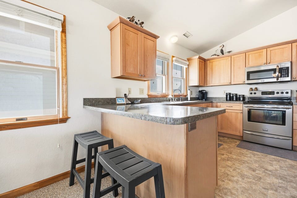 The fully equipped kitchen features modern appliances and ample counter space.