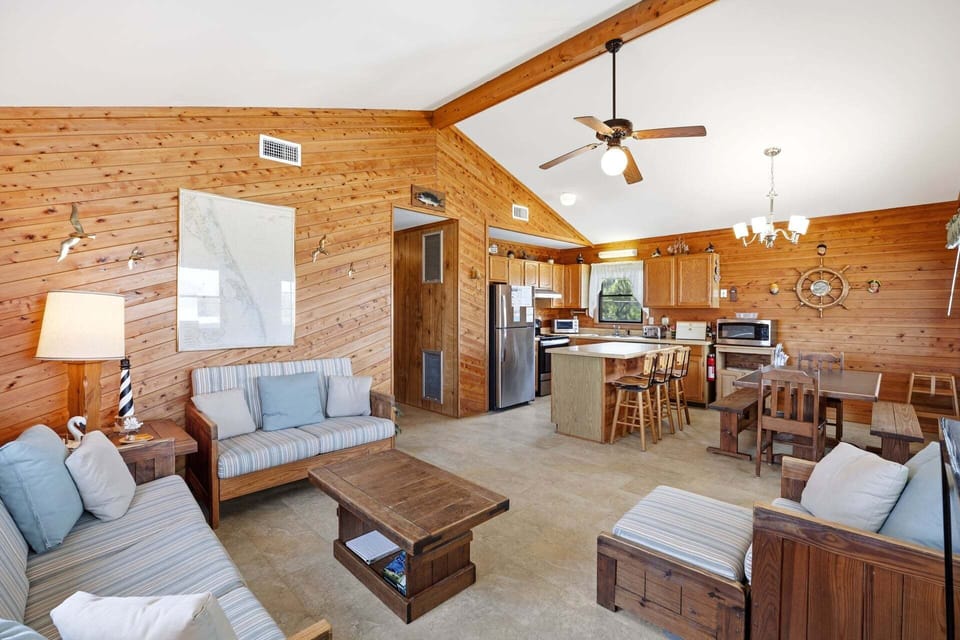 The warm wood paneling and vaulted ceilings create a welcoming coastal atmosphere.
