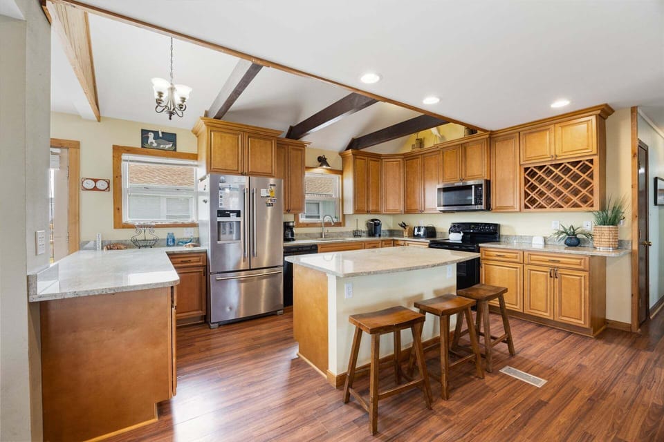 The open-concept kitchen is fully equipped with modern appliances and ample space for meal preparation.