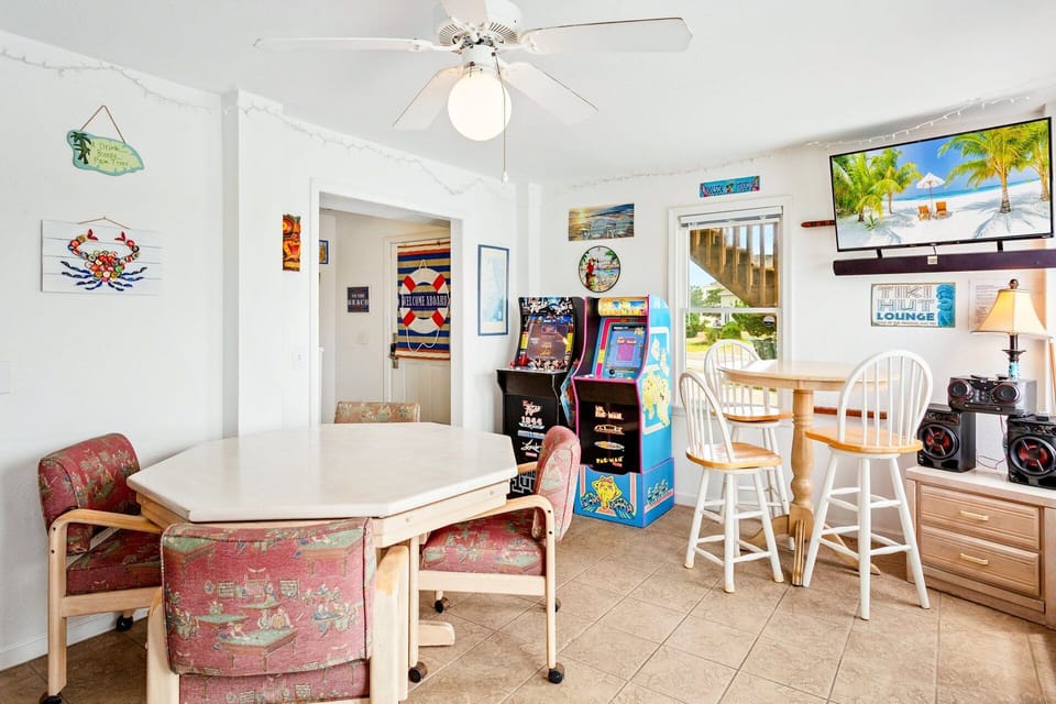 Head inside to the ground level recreation room which features a wet bar, large flat-screen TV and stereo, 2 refrigerators, microwave, card table, and video arcade gaming systems!