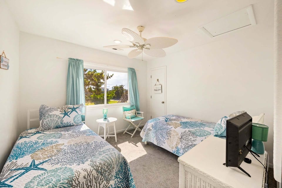 Another Double Twin Bedroom offers even more space to unwind with your favorite shows after a day at the beach!