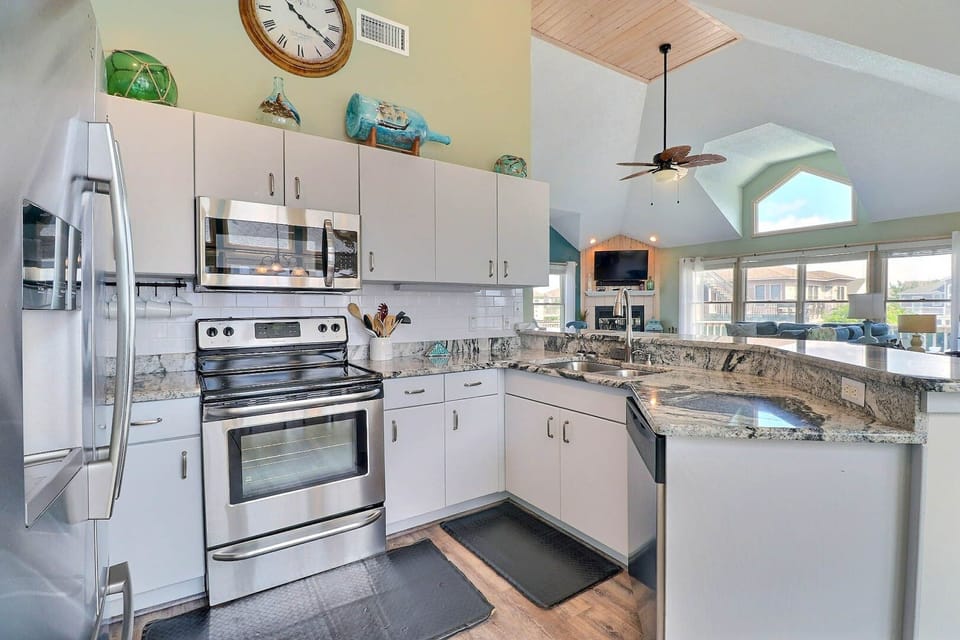 The fully equipped kitchen features stainless steel appliances, ample counter space, and everything you need to prepare meals with ease.