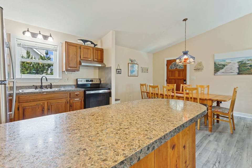 A fully-stocked kitchen with wood cabinetry, stainless steel appliances and plenty of counter space makes prepping your meal a breeze.