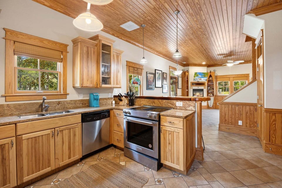 The fully equipped kitchen features stainless steel appliances, granite countertops, and everything you need for home-cooked meals.
