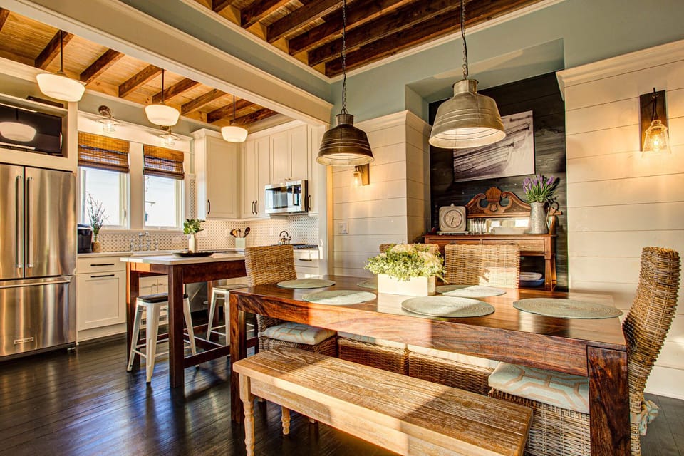 The dining area features comfortable seating and abundant natural light, providing a welcoming space for family meals while enjoying ocean views.