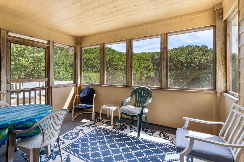 The Screened-In Porch is perfect for al fresco dining protected from the elements.