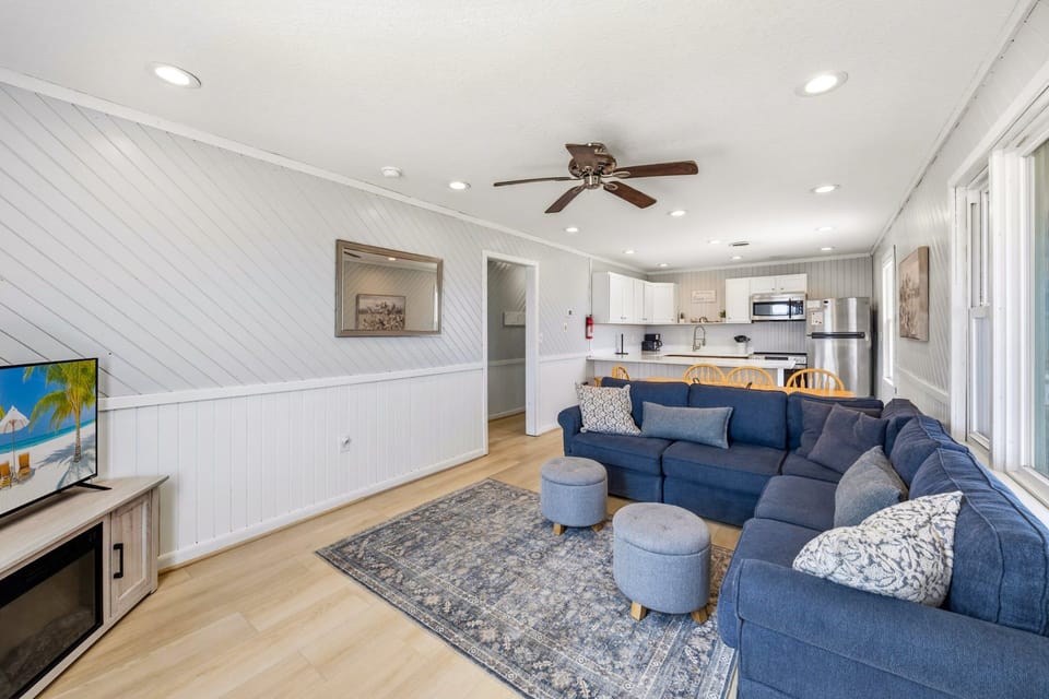 Living Area: Relax in the cozy living room with classic beach cottage charm and a flat-screen TV.