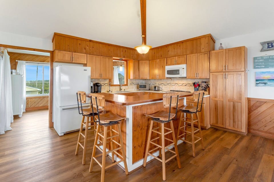 Kitchen: Cook with ease in the fully equipped kitchen featuring granite counters, hickory cabinets, and modern appliances.