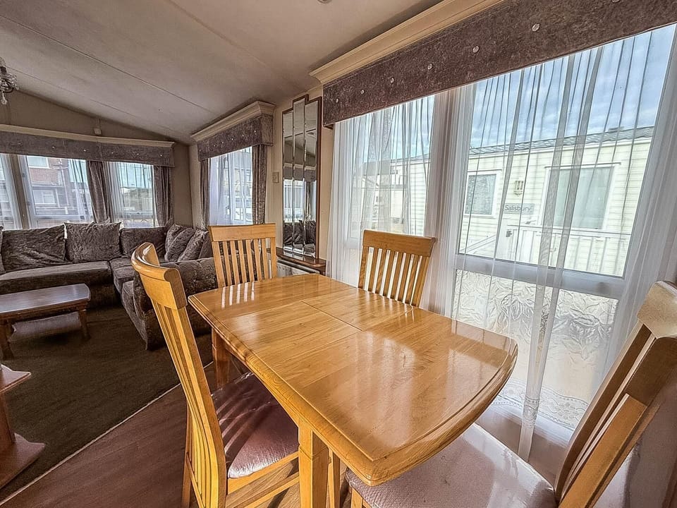 Situated conveniently opposite the kitchen, this dining table is the ideal spot for sharing meals, playing board games, or simply planning your next day's adventure on the Norfolk coast.