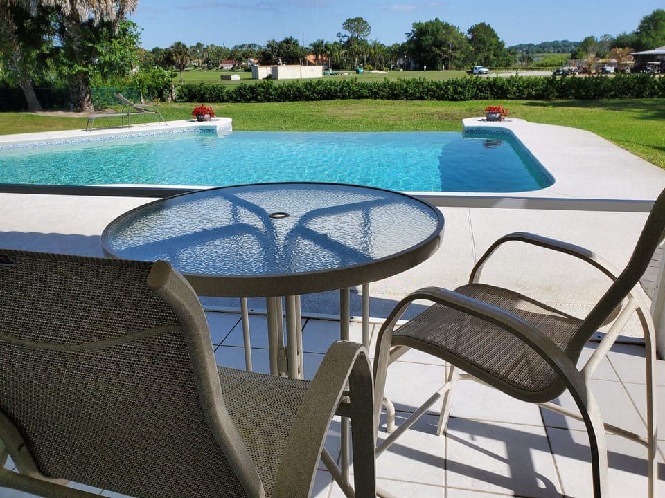 Indoor table and chairs for your morning coffee; golf course view