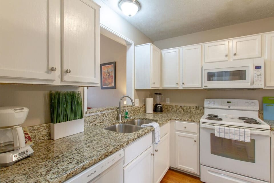 Sunny kitchen with white cabinets and plenty of counter space.