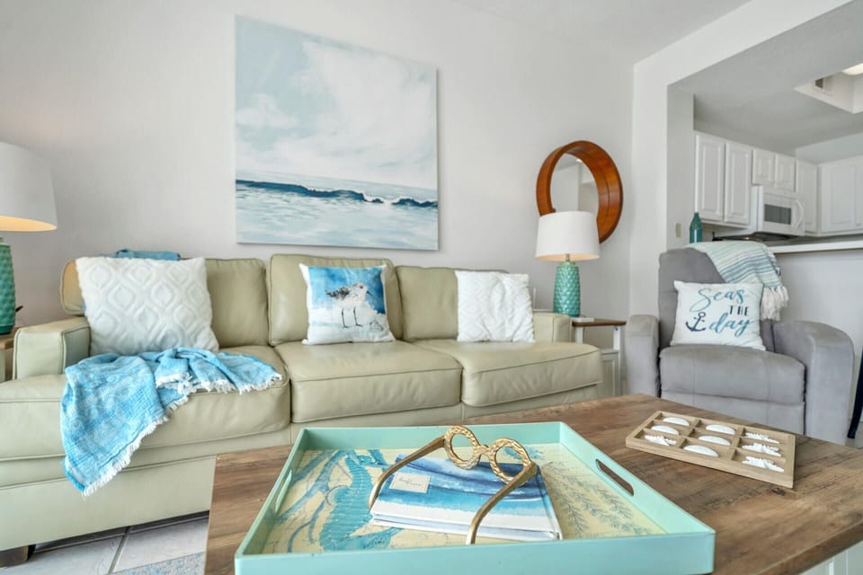 Sink into coastal comfort in your beautifully styled living area, where ocean-inspired décor and plush seating create the perfect beach retreat atmosphere.