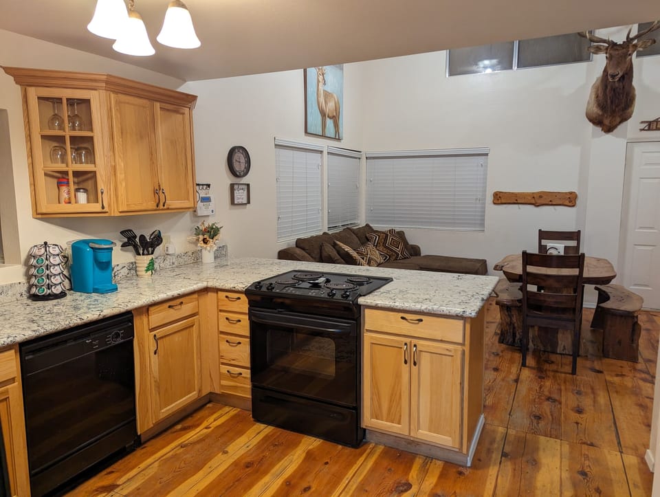 Kitchen is stocked with dishes, basic cooking tools, and single-serve coffee.