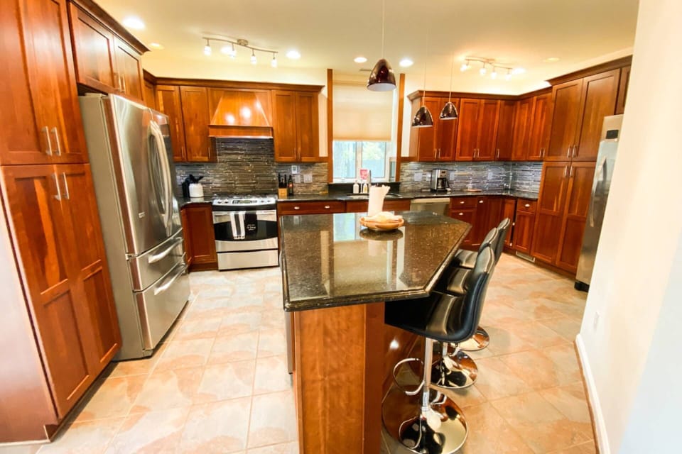 The fully-stocked gourmet kitchen has a breakfast bar with seating for 3.