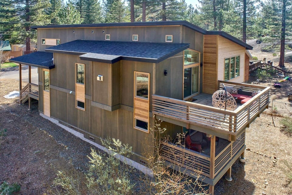 A stylish exterior with a combination of cedar and metal siding welcomes you to this modern mountain home. The upper-level deck doubles as a parking space, blending function and design.