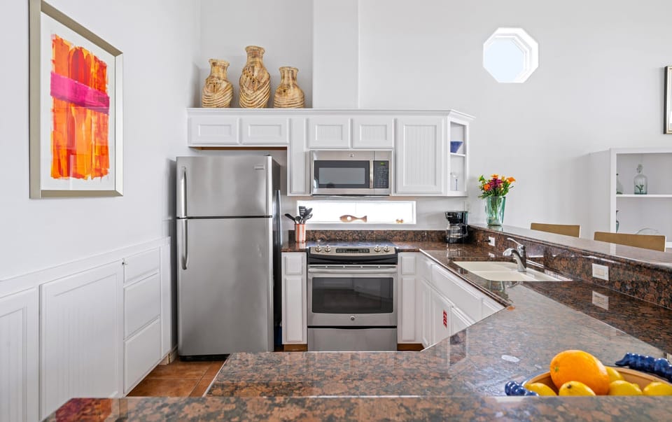 Kitchen — Stainless Appliances, White Cabinets, Granite & Octagonal Window