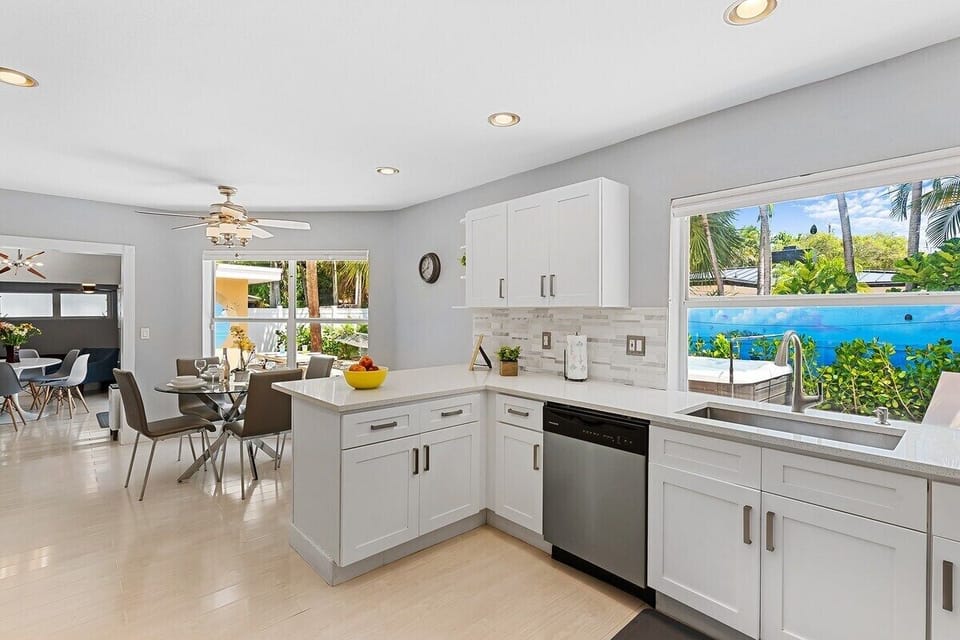 Prepare a family meal in the fully-equipped custom kitchen offering bar seating, dining table seating, updated appliances and sunny backyard patio views.