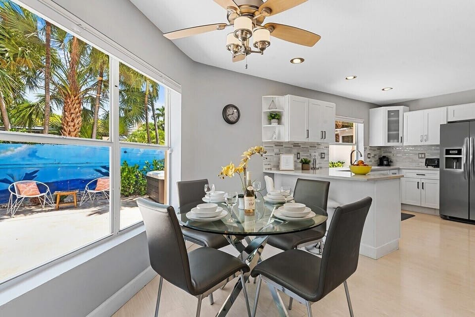 Prepare a family meal in the fully-equipped custom kitchen offering bar seating, dining table seating, updated appliances and sunny backyard patio views.