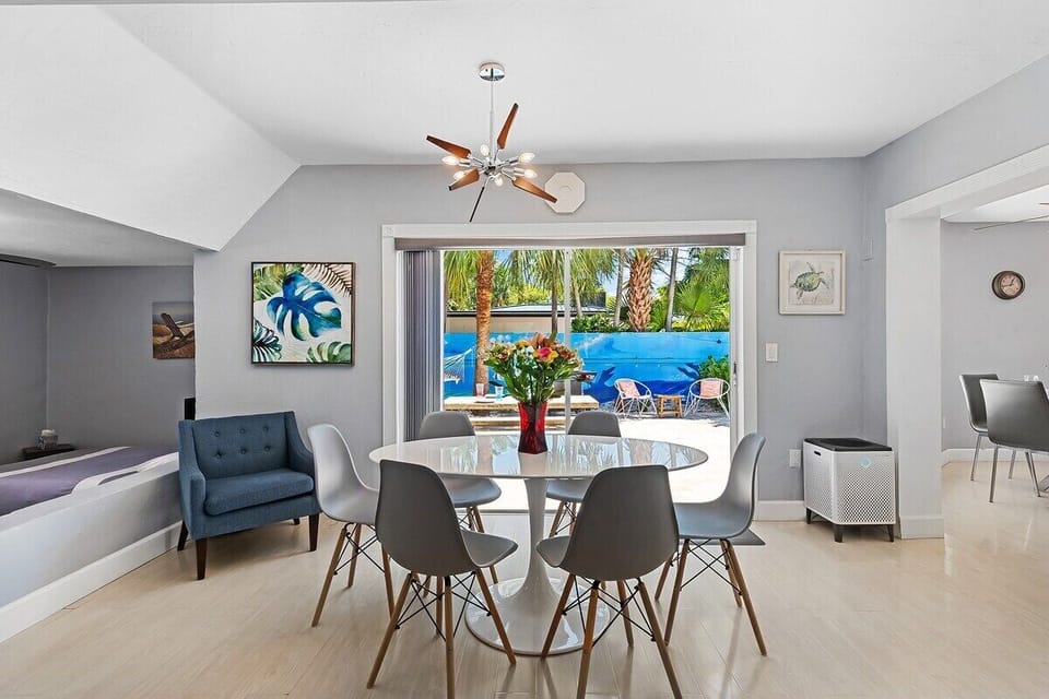 An additional dining table for six is situated in the common area with sunny backyard patio views.