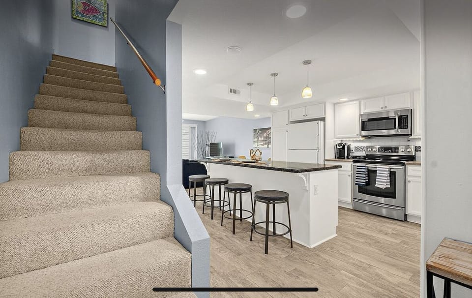 Primary bedroom, guest bedroom, and two full baths just up the stairs.