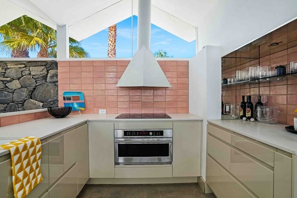 The kitchen is silky, shiny, and polished. As you can see, mid-century elements are represented all over. 