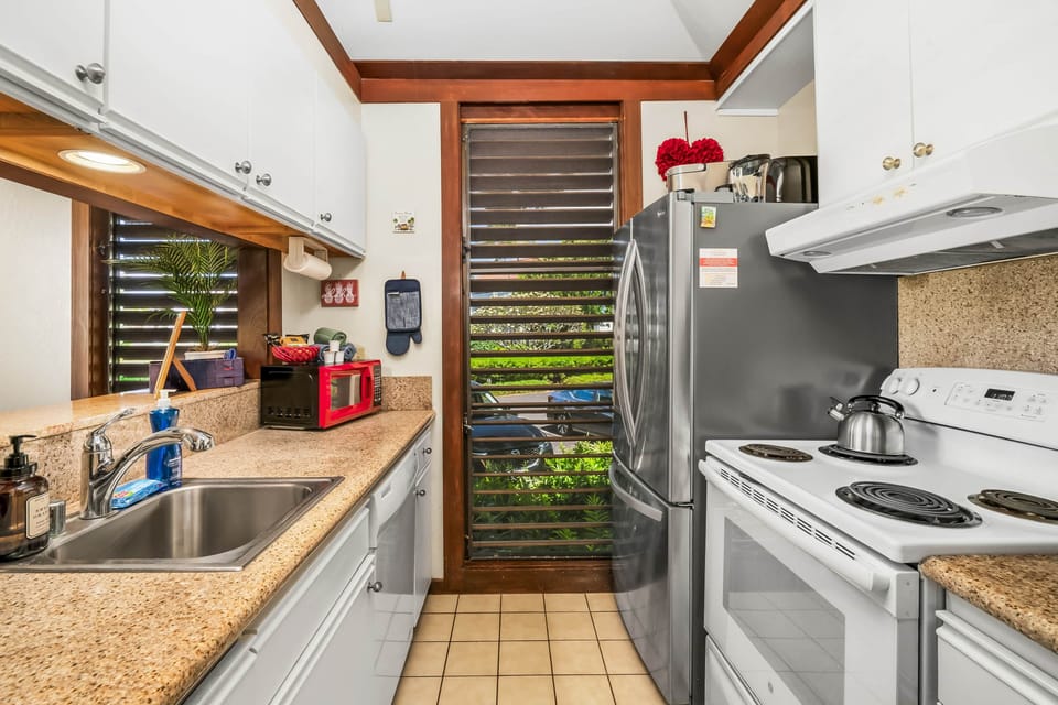 Kitchen - Step into this cozy kitchen, where modern appliances meet a touch of nature. 