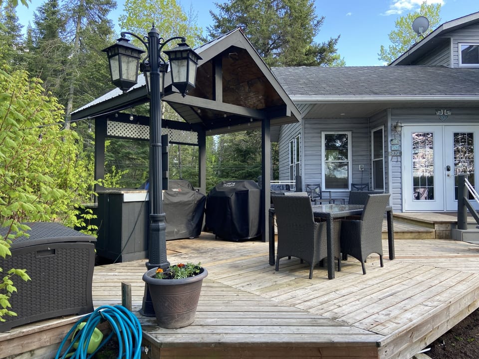 Main cottage deck with outdoor kitchen, filleting station, BBQ, and smoker.