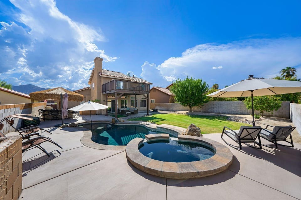 Large backyard with pool, spa, firepit, BBQ, couch and chairs and putting green!