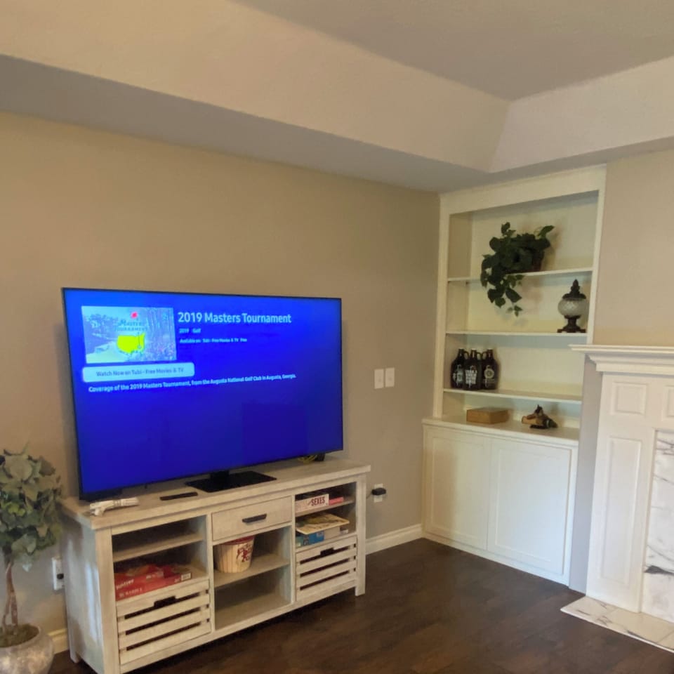 Large Smart TV with remote control in Family room. 