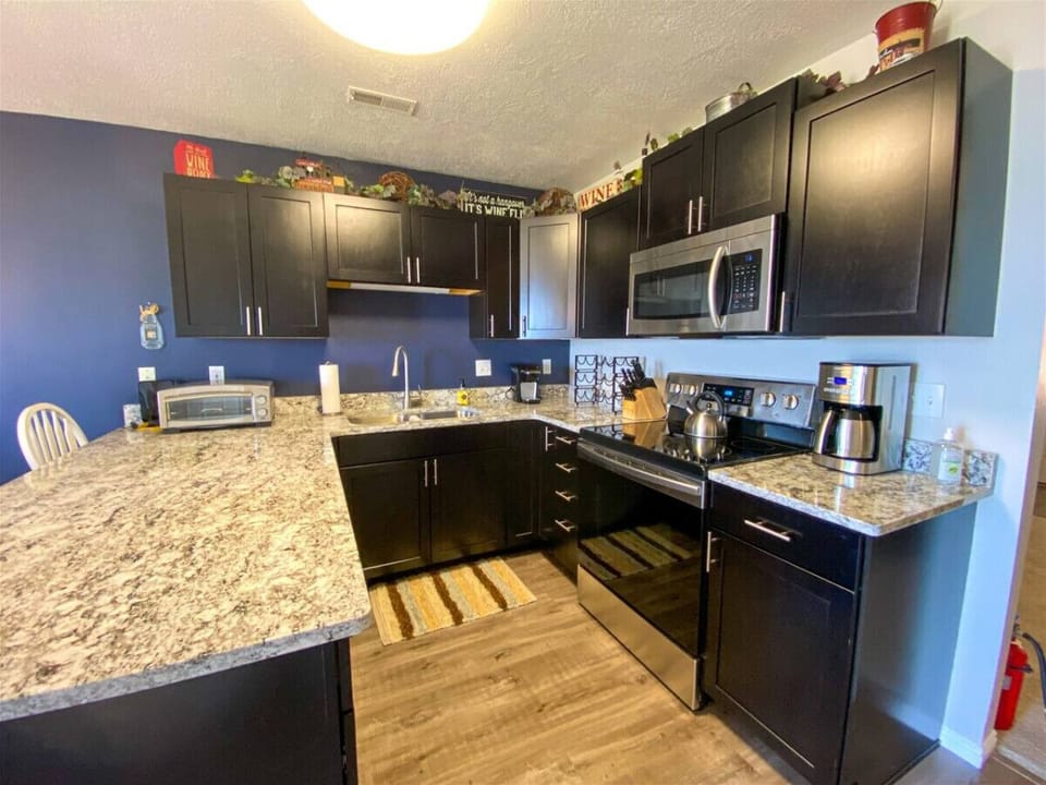 Stylish kitchen featuring spacious counters and stainless appliances