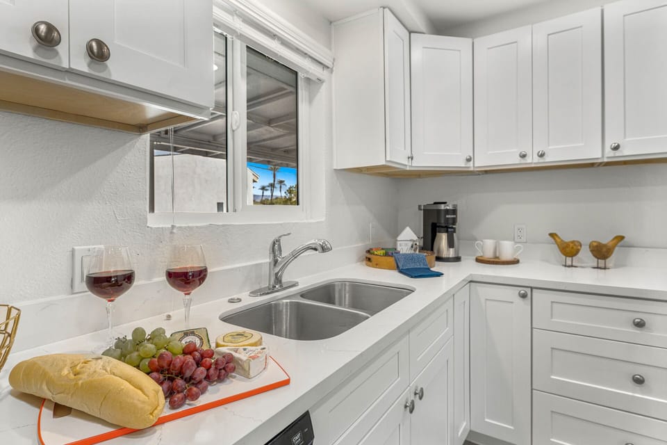 equipped with double sinks, a garbage disposal,  large refrigerator & dishwasher