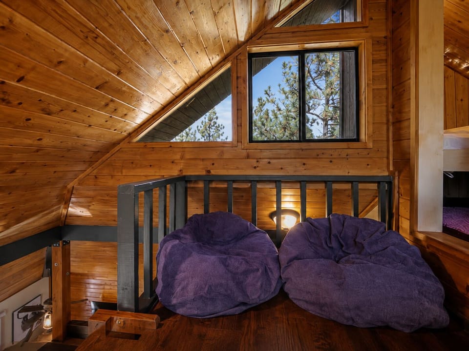 Relaxing loft lounge with bean bags in mountain cabin