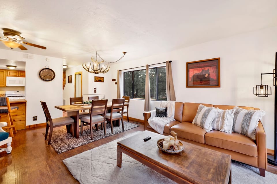 Cozy mountain living room with a fireplace, comfy seating, and smart TV—perfect for relaxing evenings, movie nights, and warm cabin vibes after outdoor adventures.