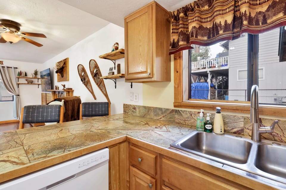 Fully equipped cabin kitchen with ample cabinetry, stove, fridge, microwave, and coffee maker—perfect for cooking meals, morning coffee, and feeling right at home on your stay.