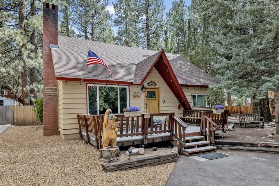 Welcoming cabin entry surrounded by towering pine trees, offering fresh mountain air and a peaceful forest setting—the perfect first impression for your Big Bear Lake getaway.