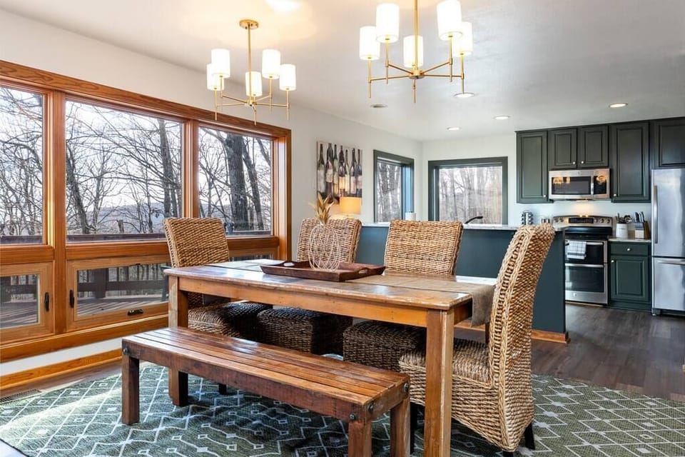 The open kitchen with a large dining table complete with mountain views.