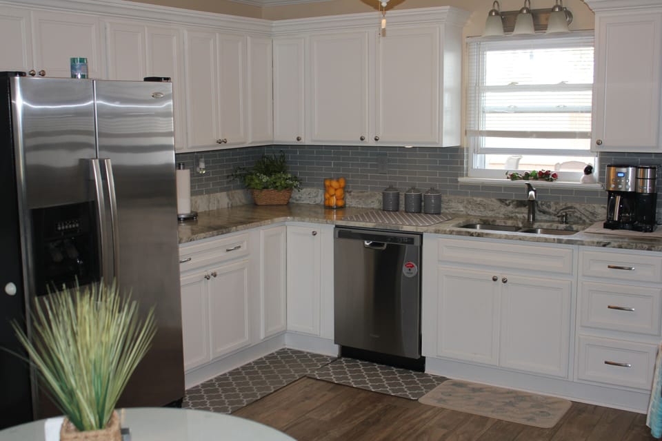 Kitchen w/stove, refrigerator, microwave, dishwasher, & coffee center