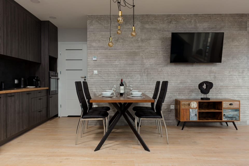 A compact kitchen featuring wooden accents, a built-in dishwasher, and ample storage space.
