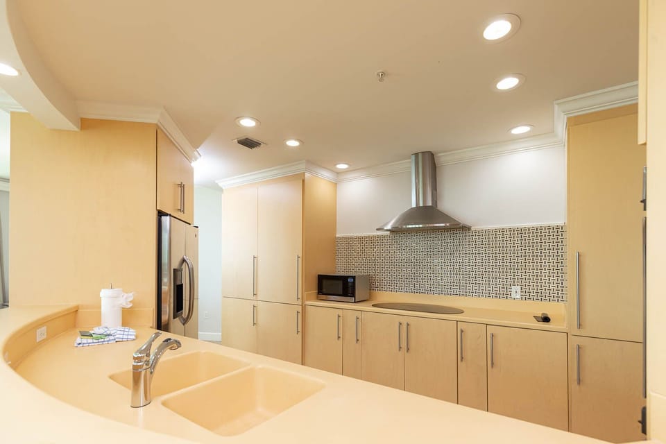 Upgrade your culinary experience in this stylish kitchen with modern stainless appliances and elegant design
