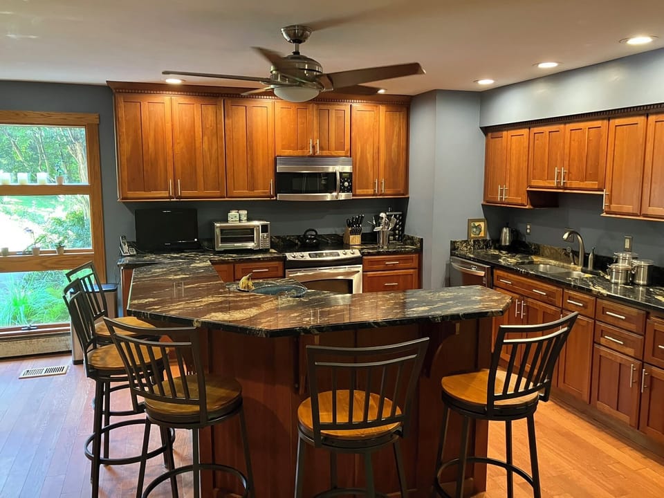 Kitchen island with gorgeous granite, seats 6 plus lower level for food prep