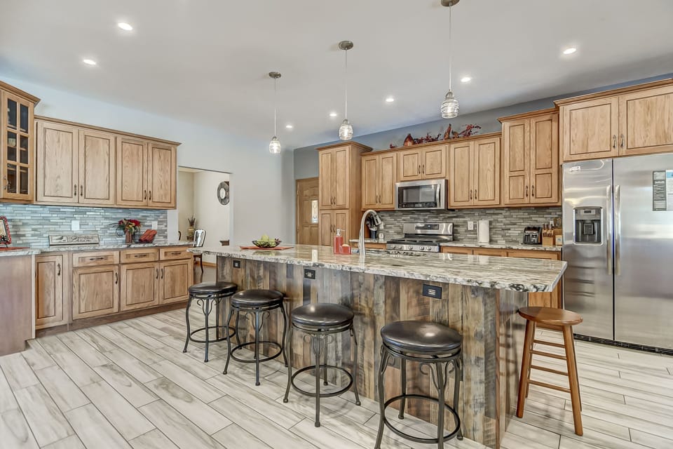 Fully stocked kitchen with modern appliances.