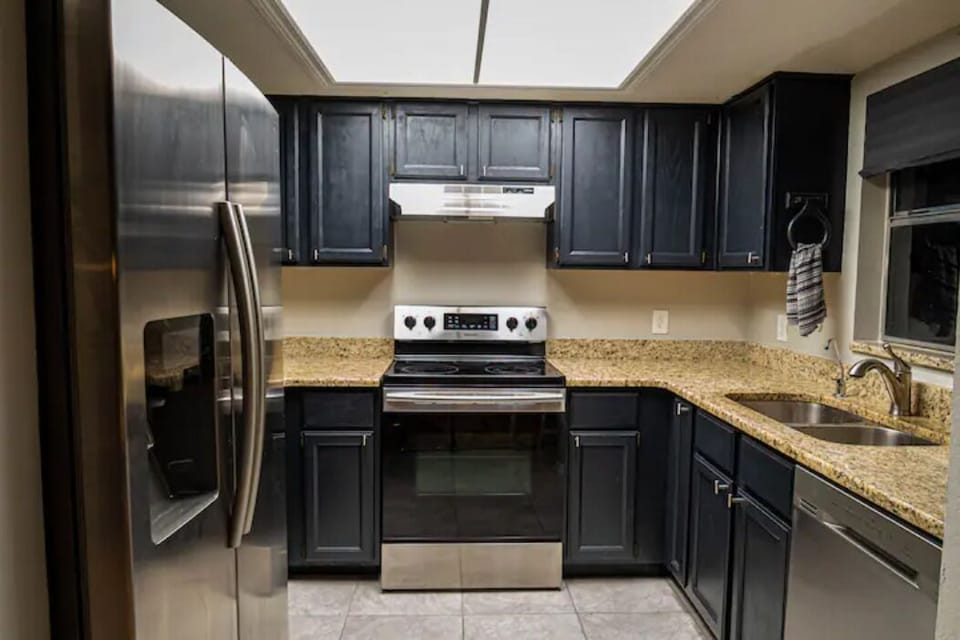 Fully equipped kitchen with toaster, coffee maker, blender, and microwave