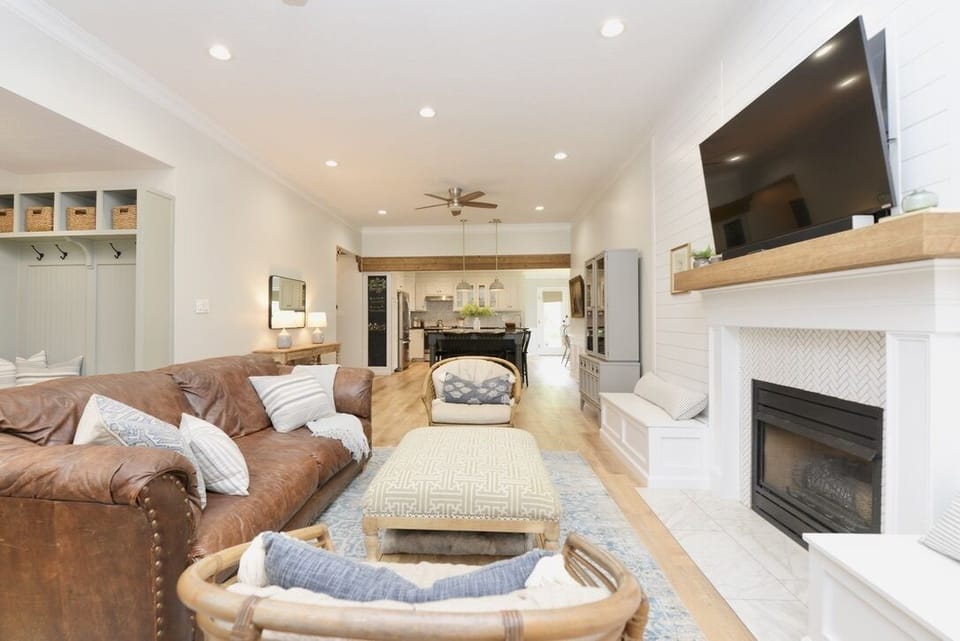 The open-concept living space has high ceilings, rustic details and antique art.