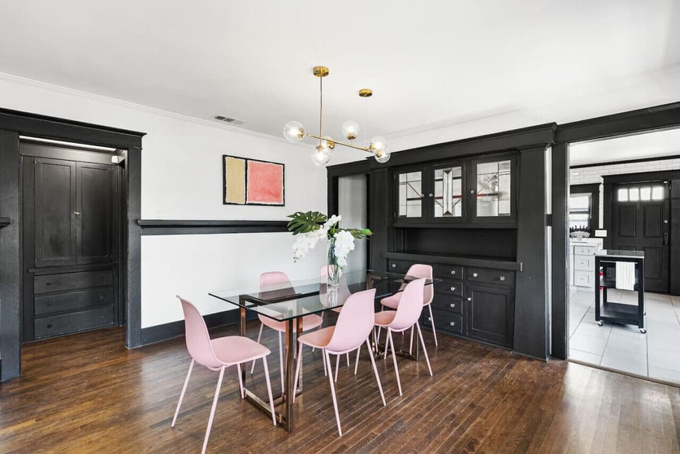Beautiful - instagram worthy Dining area featuring = CB2 dinning table and Article chairs with gorgeous floral arrangement and mid-century modern chanderlier.